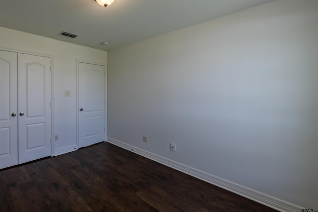 2056 Balsam Gap, Tyler, TX 75703 - unfurnished bedroom featuring dark wood finished floors, baseboards, visible vents, and a closet