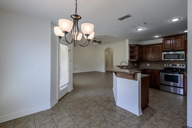 2056 Balsam Gap, Tyler, TX 75703 - kitchen featuring arched walkways, appliances with stainless steel finishes, open shelves, and visible vents