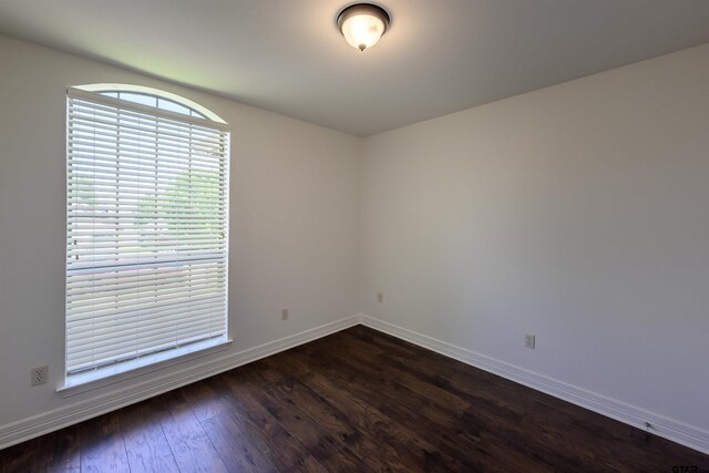 2056 Balsam Gap, Tyler, TX 75703 - spare room with baseboards and dark wood-style flooring