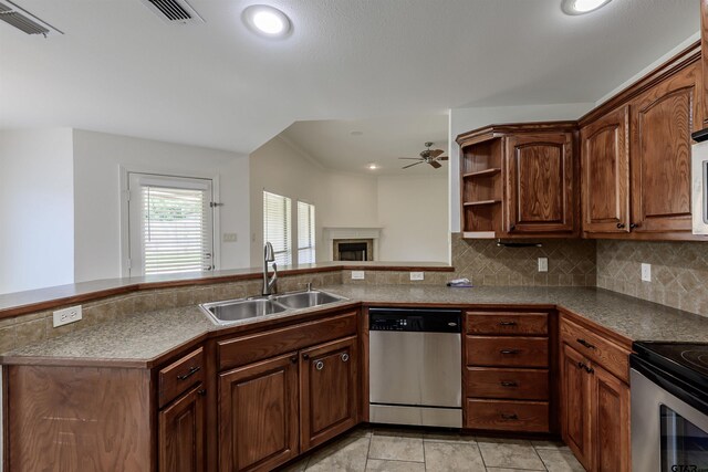 2056 Balsam Gap, Tyler, TX 75703 - kitchen with a ceiling fan, tasteful backsplash, a sink, a fireplace, and appliances with stainless steel finishes