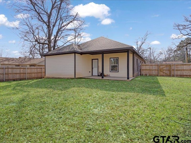 back of house with a patio area, a fenced backyard, and a lawn