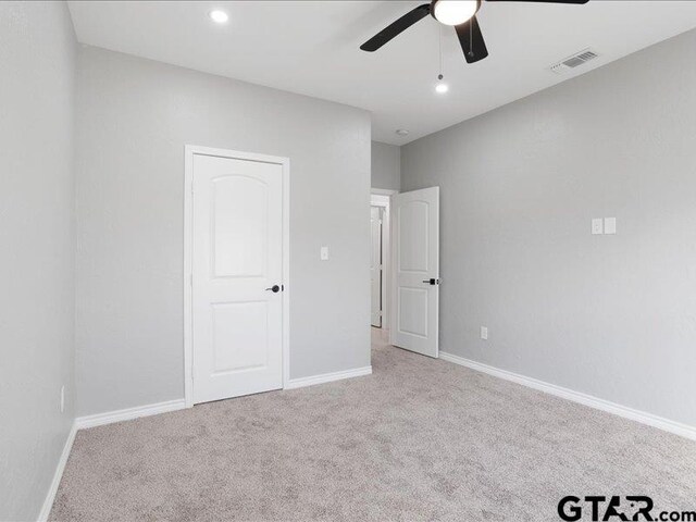 unfurnished bedroom with ceiling fan, recessed lighting, visible vents, baseboards, and carpet