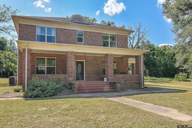 front of property with a front yard, a porch, and central air condition unit