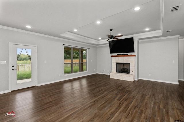 unfurnished living room with a fireplace, a wealth of natural light, and dark hardwood / wood-style flooring