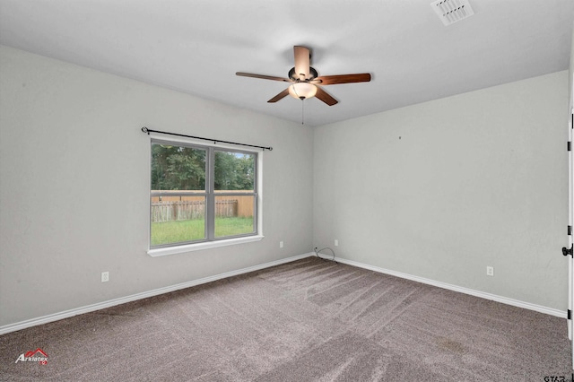 spare room featuring carpet and ceiling fan