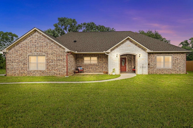 ranch-style house featuring a yard