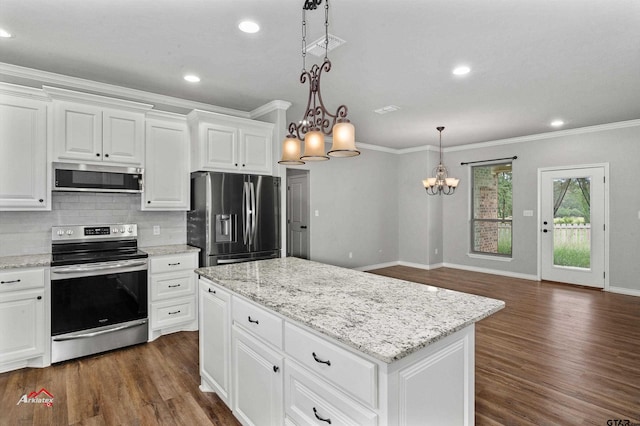 kitchen featuring white cabinets, stainless steel appliances, dark hardwood / wood-style floors, and decorative light fixtures