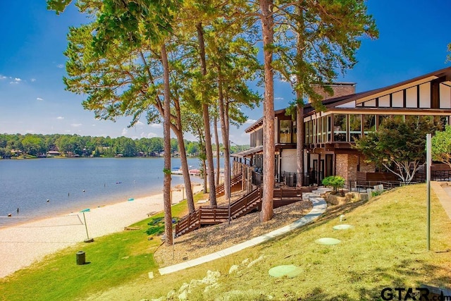 exterior space featuring a water view and a beach view