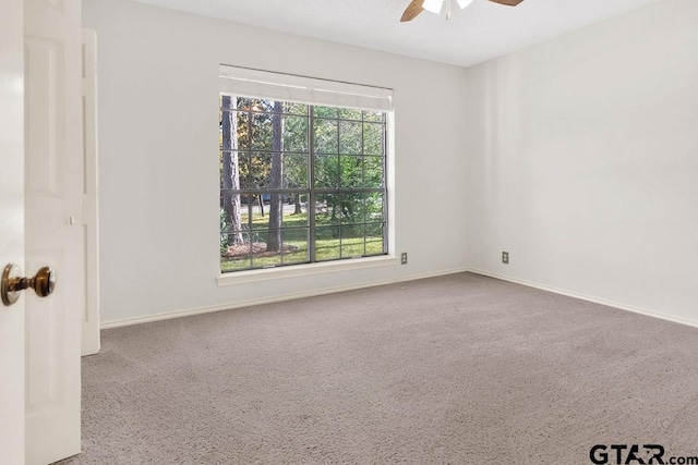 carpeted empty room with ceiling fan and a healthy amount of sunlight