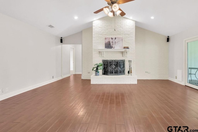 unfurnished living room featuring a fireplace, wood-type flooring, ceiling fan, and lofted ceiling