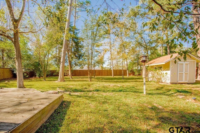 view of yard with a storage shed and a deck