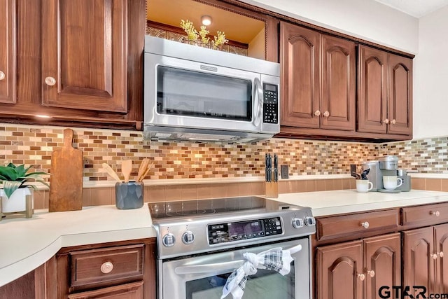 kitchen with tasteful backsplash and stainless steel appliances