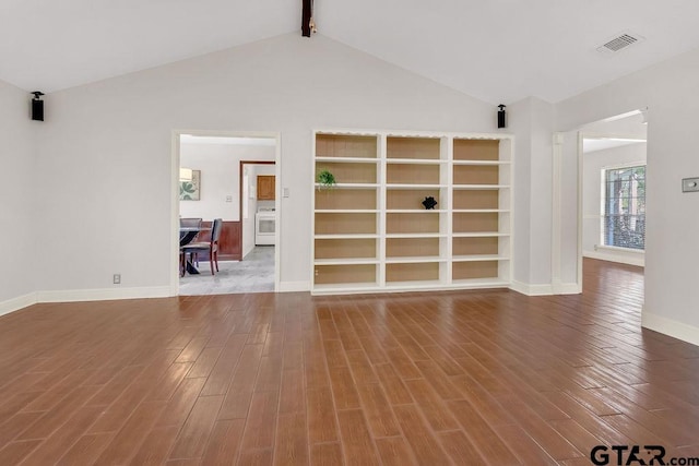 interior space with lofted ceiling with beams and wood-type flooring