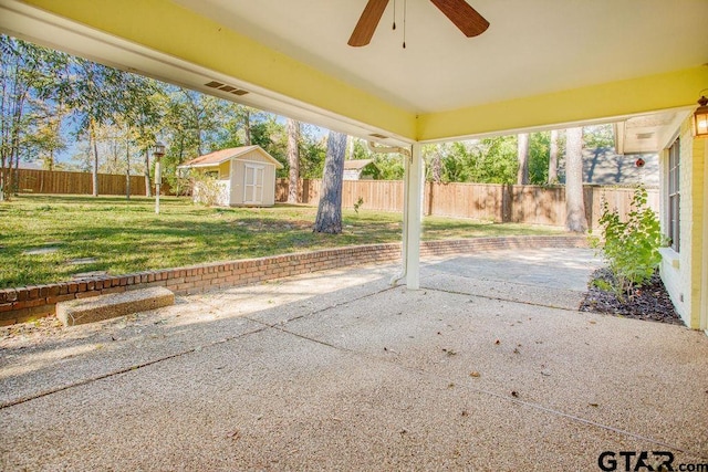 view of patio with ceiling fan and a storage unit