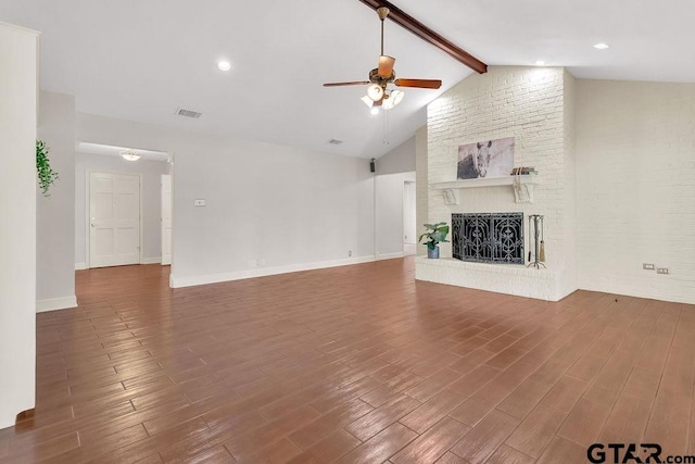 unfurnished living room with vaulted ceiling with beams, dark hardwood / wood-style floors, a brick fireplace, and ceiling fan