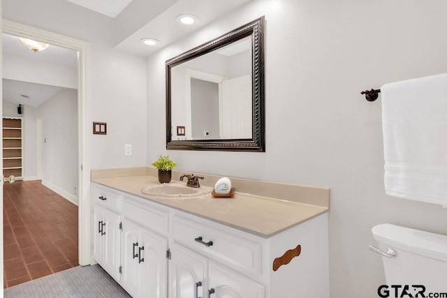 bathroom featuring hardwood / wood-style floors, vanity, and toilet