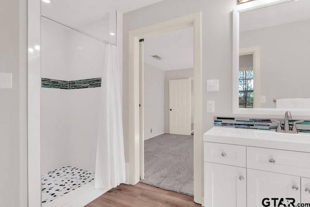 bathroom featuring hardwood / wood-style floors, vanity, and a shower with shower curtain