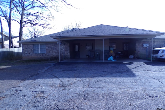 back of property with a carport