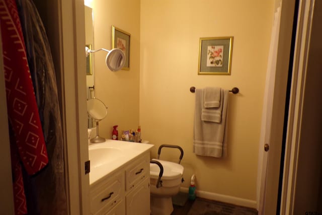 bathroom featuring toilet and vanity