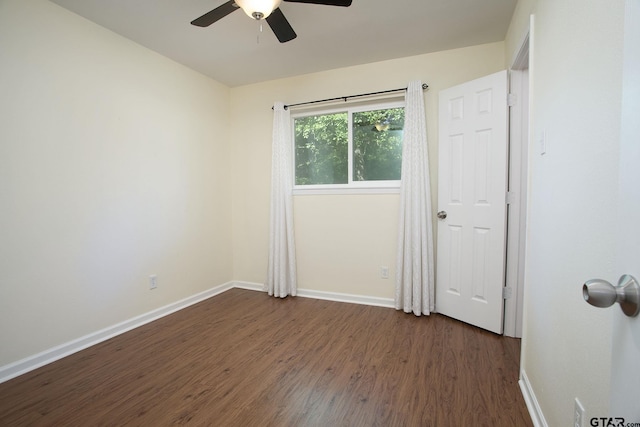16530 Echo Glen Dr, Tyler, TX 75703 - empty room with dark wood-type flooring, ceiling fan, and baseboards