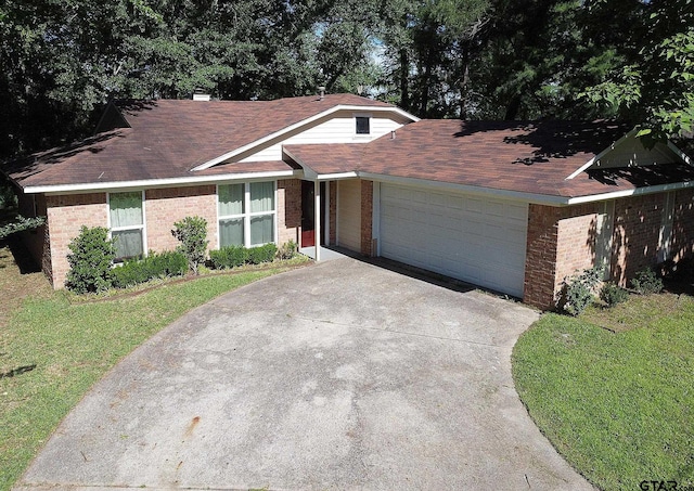 16530 Echo Glen Dr, Tyler, TX 75703 - view of front facade with brick siding, driveway, a garage, and a front lawn