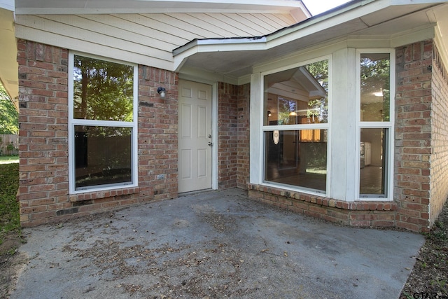 16530 Echo Glen Dr, Tyler, TX 75703 - view of exterior entry featuring a patio and brick siding