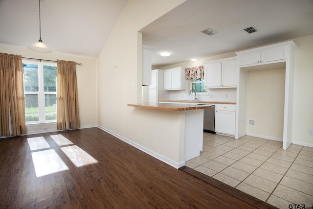 16530 Echo Glen Dr, Tyler, TX 75703 - kitchen featuring stainless steel dishwasher, healthy amount of natural light, a sink, light wood-type flooring, and lofted ceiling
