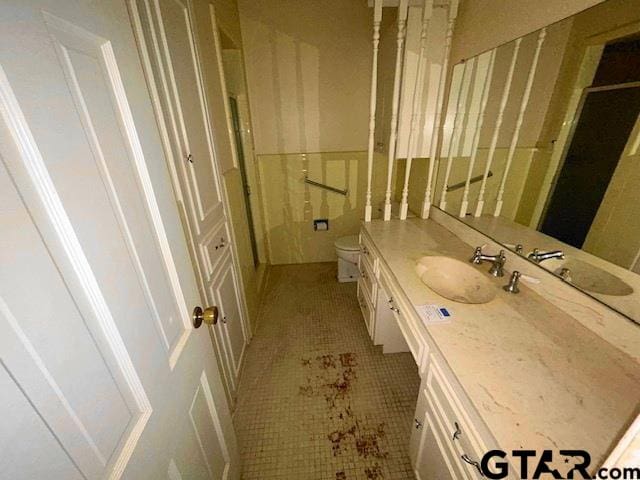 bathroom featuring vanity, tile patterned floors, and toilet