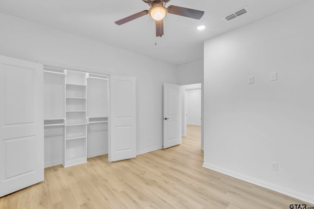 unfurnished bedroom with light wood-type flooring, a closet, and ceiling fan