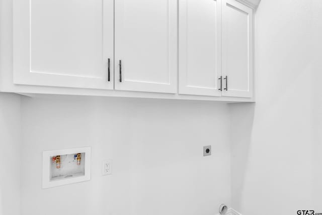 clothes washing area featuring electric dryer hookup, cabinets, and washer hookup