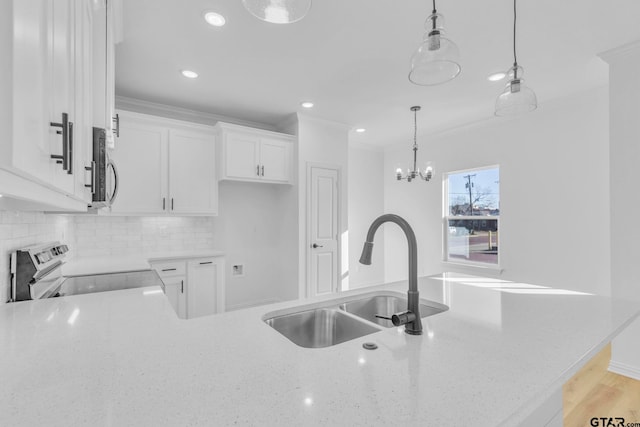 kitchen featuring crown molding, sink, electric range, decorative light fixtures, and white cabinets