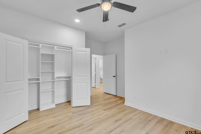 unfurnished bedroom with a closet, light hardwood / wood-style flooring, and ceiling fan