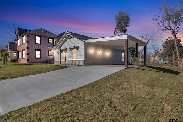 view of front facade with a yard and a carport