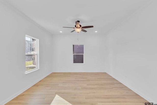 spare room with light wood-type flooring, ceiling fan, and ornamental molding