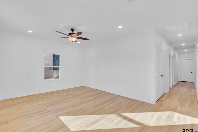 empty room featuring light hardwood / wood-style flooring, ceiling fan, and crown molding