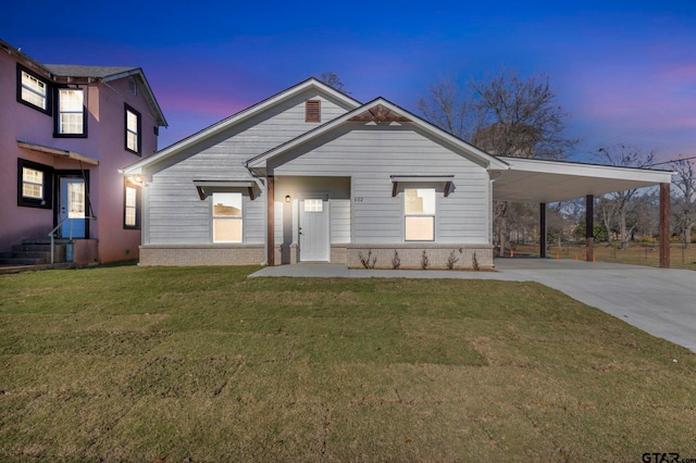 view of front of home featuring a yard and a carport