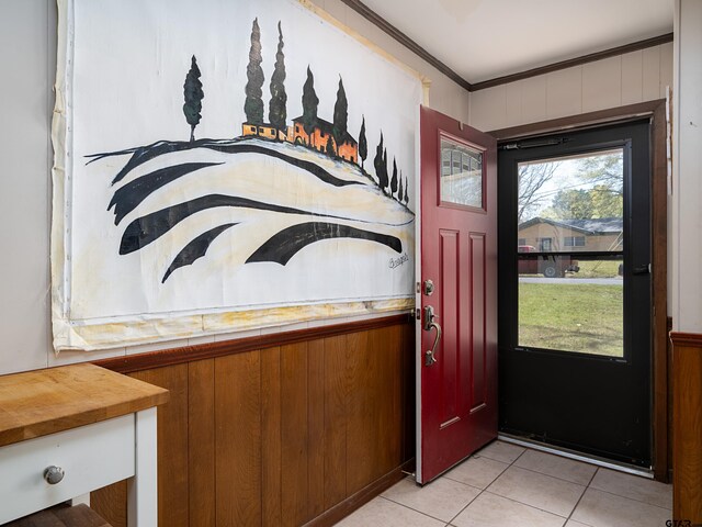 entrance foyer featuring light tile patterned flooring and ornamental molding