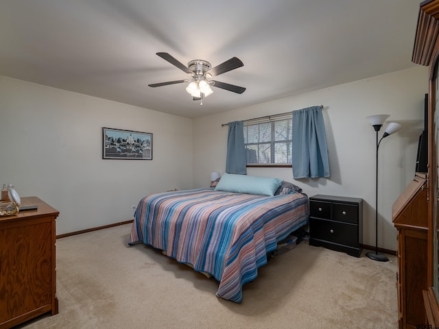 bedroom with light carpet, baseboards, and a ceiling fan