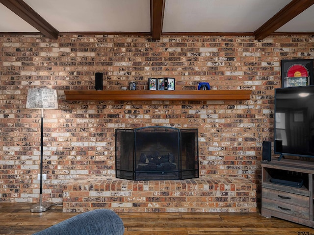 interior details with crown molding, wood finished floors, and beam ceiling