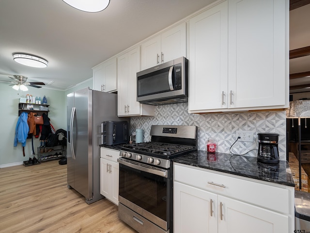 kitchen featuring white cabinetry, decorative backsplash, light wood-style floors, ceiling fan, and appliances with stainless steel finishes