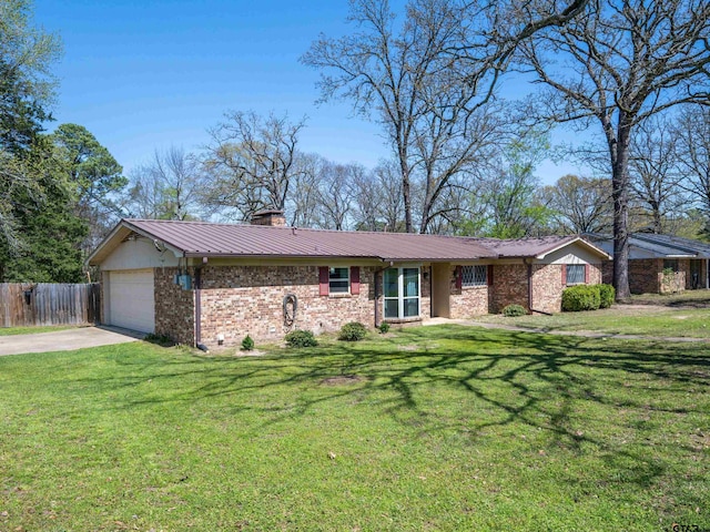 ranch-style house with concrete driveway, an attached garage, fence, a front lawn, and metal roof