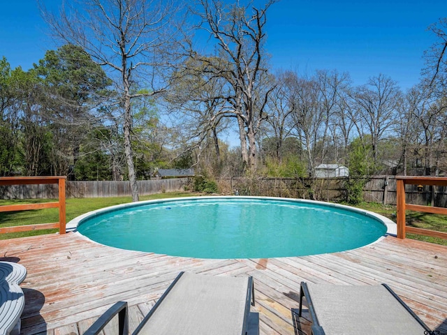 view of pool featuring a fenced backyard, a deck, and a fenced in pool