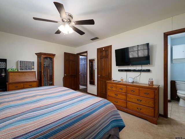bedroom with a ceiling fan, light carpet, connected bathroom, and visible vents