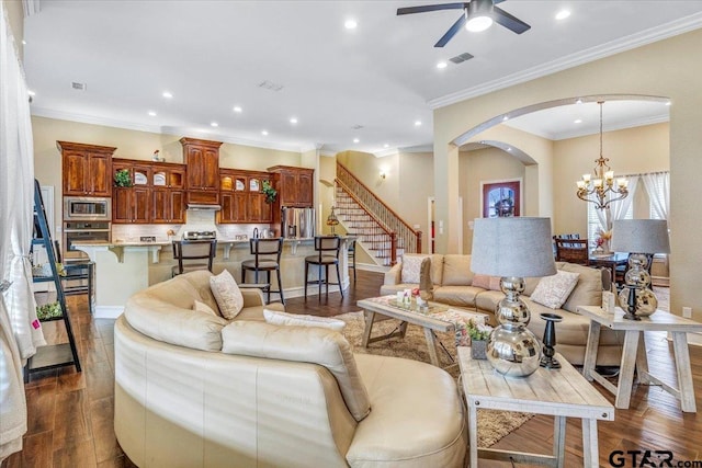 living room with stairs, ceiling fan with notable chandelier, recessed lighting, and dark wood-style flooring