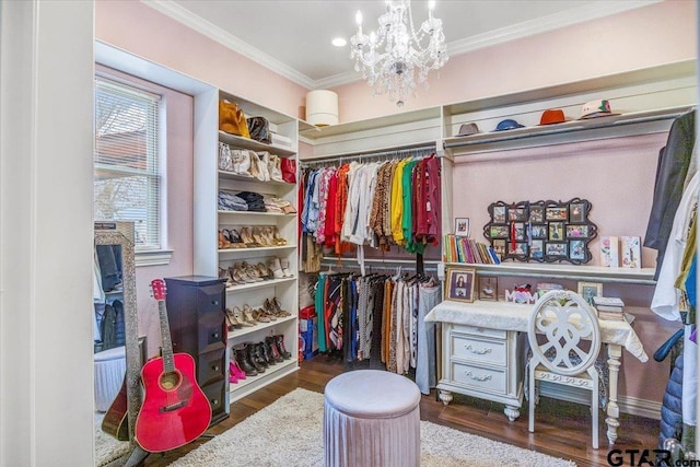 spacious closet with wood finished floors and a chandelier