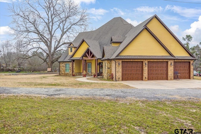 view of front facade featuring driveway, an attached garage, a shingled roof, a front lawn, and brick siding