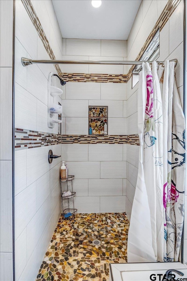 full bathroom with a tile shower