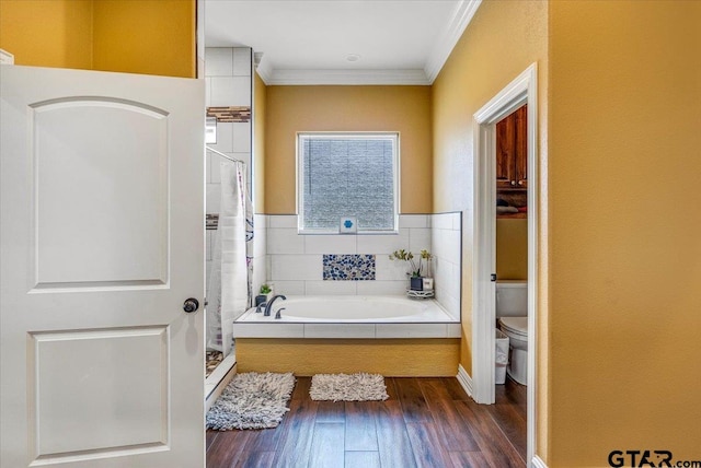 bathroom with a shower stall, toilet, a bath, and ornamental molding