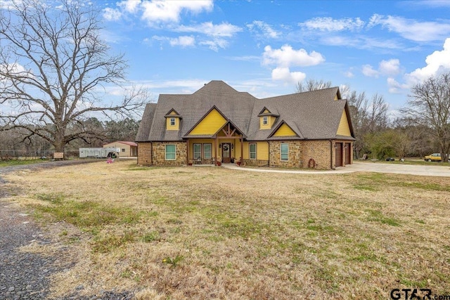 view of front facade with a garage, concrete driveway, and a front yard