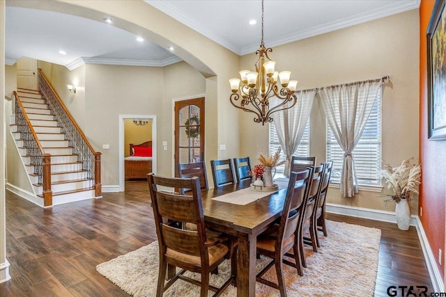 dining area with crown molding, baseboards, stairway, wood finished floors, and arched walkways